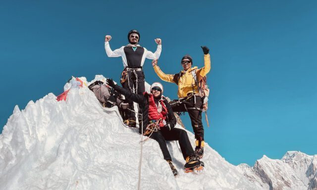 LHO summiteers Zeid Shair and Melissa Jefferies celebrating on the summit of Lobuche East, with stunning panoramic views of the Himalayas in the background.