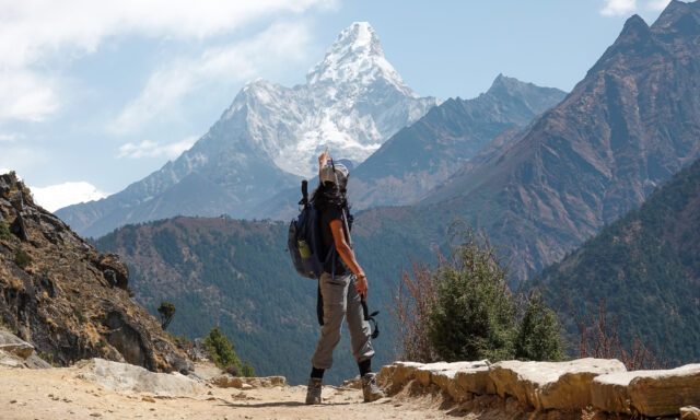 A hiker enjoying the view of Ama Dablam in the Khumbu Valley during the Life Happens Outdoors Everest Base Camp Trek