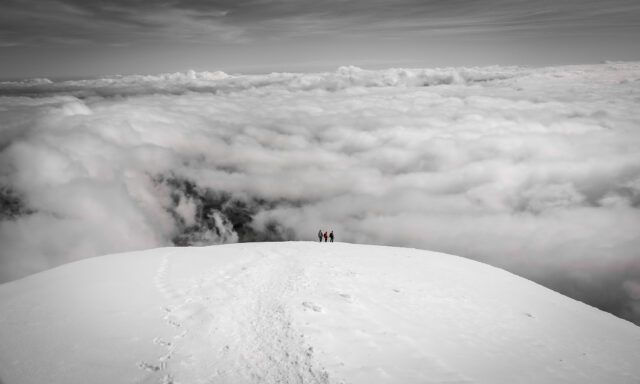 The Life Happens Outdoors team disappearing into the clouds as we descended Cotopaxi during the Climb Cotopaxi & Climb Chimborazo Expedition.