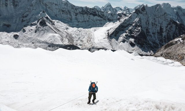 Roberto David abseiling down the headwall of Island Peak with the towering summit of Makalu in the background.