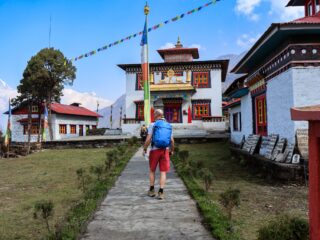 Trekker visiting a Buddhist monastery on the approach trail to Mera Peak in Nepal.