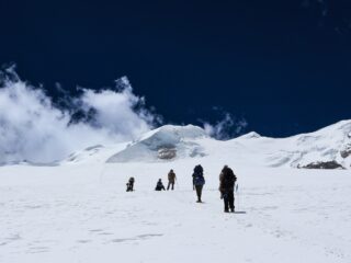 Climbers crossing the glacier on the guided summit route to Mera Peak in Nepal.