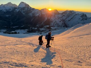 Roped climbers ascending Mera Peak at sunrise during the expedition’s summit push.