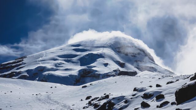 The Ventimilla summit appearing through the clouds as the Life Happens Outdoors team approached Chimborazo Base Camp during the Climb Cotopaxi & Climb Chimborazo Expedition.