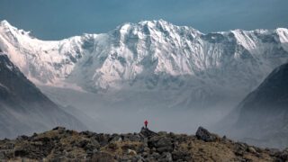 An epic capture of LHOer Hind Choueiry by LHO Team Leader and Founder Rami Rasamny, as she stands alone at the edge of the glacier moraine, showcasing the perspective of just how gigantic the South Face of Annapurna is during the Annapurna Base Camp Trek with the Life Happens Outdoors team.