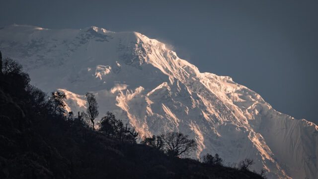 The glaciers of Annapurna South contrasted against the forests as seen from Jhinhu during the Annapurna Base Camp Trek with the Life Happens Outdoors team.