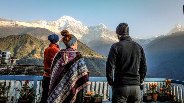 LHOers in Chomrong village at sunrise, with the Annapurna Sanctuary ahead of them in the valley and Annapurna South fully in view on the horizon during the Annapurna Base Camp Trek with the Life Happens Outdoors team.