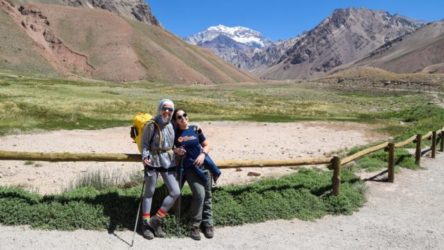 Nada Abanda and her daughter Anoud Gharaibeh at the start of the Aconcagua trail with the South Face of Aconcagua visible in the background during the Aconcagua Expedition with the Life Happens Outdoors team.