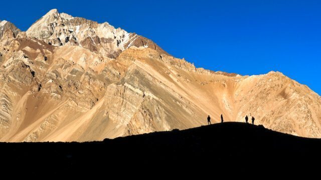 The Life Happens Outdoors team enjoying the view on a hill above Confluencia on the first night of the trail during the climb Aconcagua Expedition.