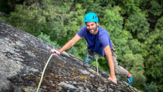 Gino Traboulsi climbing above the Valorcine forest during the Rock Climbing in Chamonix trip with the Life Happens Outdoors team.