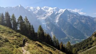 Accessing the Les Aiguilles de Chamonix crag with stunning views of Mont Blanc and the Chamonix Valley in the background during the Rock Climbing in Chamonix trip with the Life Happens Outdoors team.