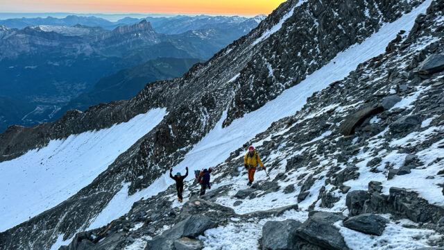 LHOers Hannah Piercy and Gino Traboulsi being led by LHO IFMGA mountain guide Pavlos Tsiantos across the Grand Couloir during the summit push of Mont Blanc with the Life Happens Outdoors team.