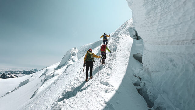 Life Happens Outdoors team climbing Mont Blanc on the summit ridge with glaciers in view during the Climb Mont Blanc Summit Course.