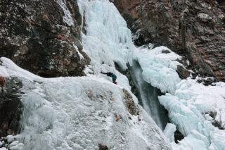 LHOer scaling a waterfall in Cogne during the Ice Climbing in Cogne adventure with the Life Happens Outdoors team.