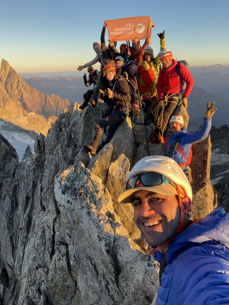 LHO Founder Rami Rasamny taking a selfie on the summit of the mountain with the Life Happens Outdoors Team at sunrise.