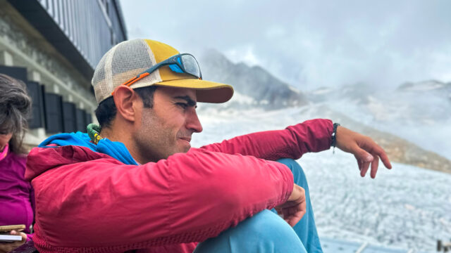 Rami Rasamny sitting on the terrace of the Albert Premiere Hut overlooking the Le Tour Glacier during a Life Happens Outdoors expedition in the Alps.