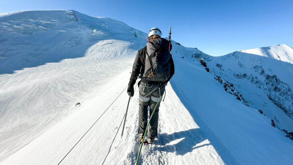 Life Happens Outdoors climber Hannah Piercy crossing the Aiguille du Goûter ridge en route to the Goûter Hut on the Mont Blanc ascent via the normal route.