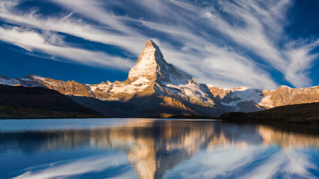 Sunrise on the Stellisee lake. Reflection of Matterhorn peak in the watter surface. Beautiful outdoor scene in Swiss Alps, Zermatt location, Valais canton, Switzerland, Europe.