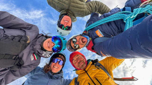 Cover image showing a group of Life Happens Outdoors adventurers celebrating at sunset on a mountain ridge with festive lights, symbolizing the NYE sale.