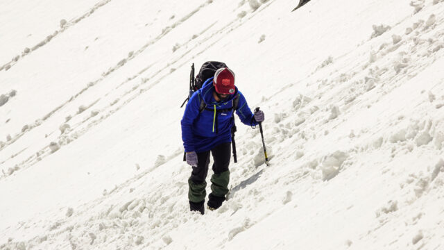 Life Happens Outdoors climber ascending rugged snowy slopes on Paldor Peak, showcasing sustainable adventure travel and zero waste practices.
