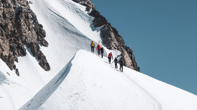 Life Happens Outdoors team ascending the moguls below the Mont Blanc summit during a Mont Blanc guided climb, showcasing skill and determination.