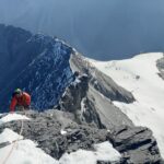 Jean Louis Moukarzel of Life Happens Outdoors ascending the narrow, snow-covered Mitellegi Ridge of the Eiger, surrounded by dramatic alpine peaks and deep valleys, capturing the challenge and beauty of his journey as recounted in the article 