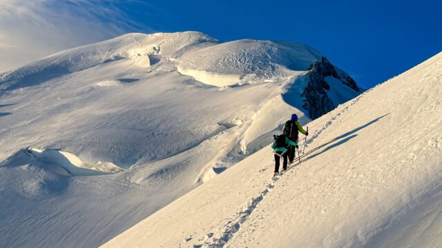 LHO team climbing above the second mogul on Mont Blanc just after sunrise, making their way toward the summit on the classic Gouter route.
