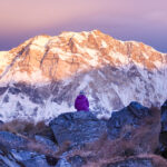 A Life Happens Outdoors community member stands in quiet contemplation at sunrise, gazing toward the towering south face of Annapurna.