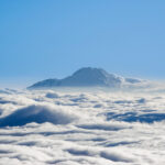 View of Chimborazo rising above the clouds as seen from Cotopaxi, captured during a Life Happens Outdoors expedition in the Ecuadorian Andes.