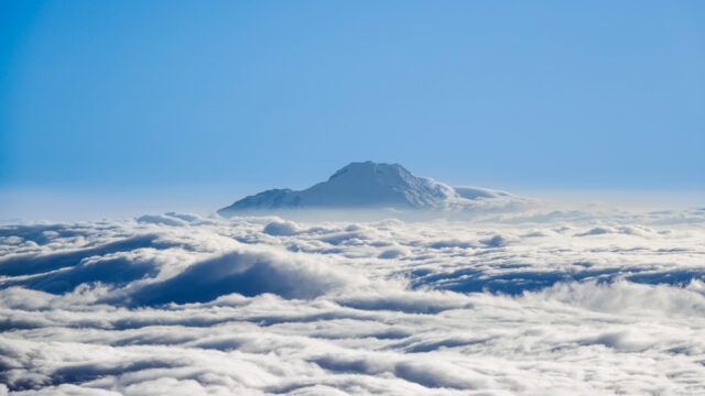 View of Chimborazo rising above the clouds as seen from Cotopaxi, captured during a Life Happens Outdoors expedition in the Ecuadorian Andes.