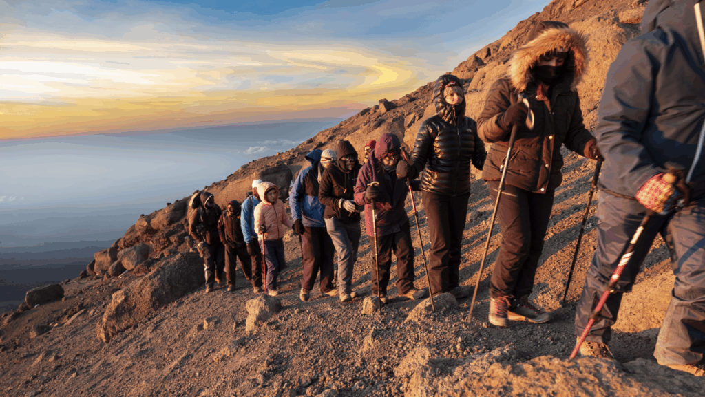 Life Happens Outdoors team in golden hour light below Stella Point on the Machame Route during a Kilimanjaro summit attempt