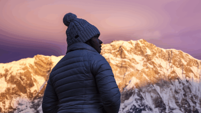 Life Happens Outdoors community member watching sunrise at Annapurna Base Camp with Annapurna South in the Annapurna Sanctuary