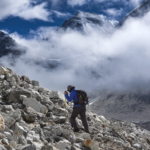 Life Happens Outdoors trekker hiking a few hours from Everest Base Camp as clouds break to reveal the Khumbu mountain range in Nepal