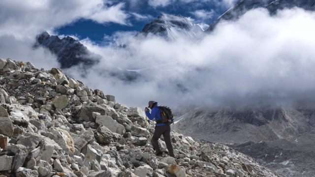 Life Happens Outdoors trekker hiking a few hours from Everest Base Camp as clouds break to reveal the Khumbu mountain range in Nepal
