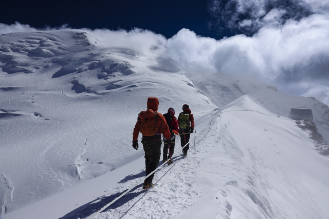 Life Happens Outdoors climbers beneath the Dôme du Goûter on the approach to the Goûter Hut during a Mont Blanc climb