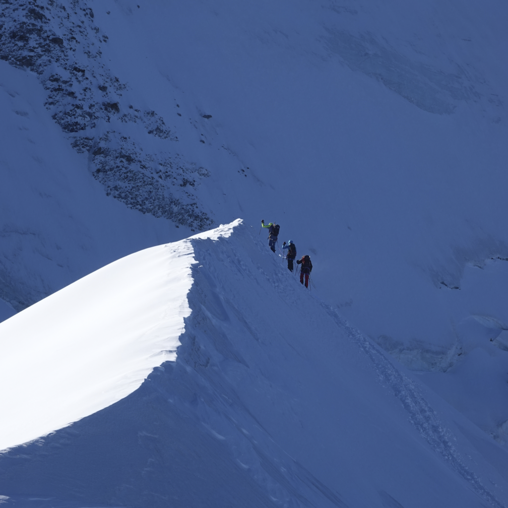 Three Life Happens Outdoors climbers ascending outside the Goûter Hut on their Mont Blanc summit attempt
