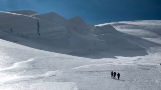 Life Happens Outdoors climbers ascending the Dôme du Goûter switchbacks below the glacier seracs on Mont Blanc.