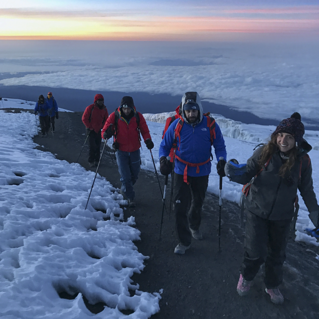 Life Happens Outdoors community members at sunrise moments before reaching the summit of Mount Kilimanjaro