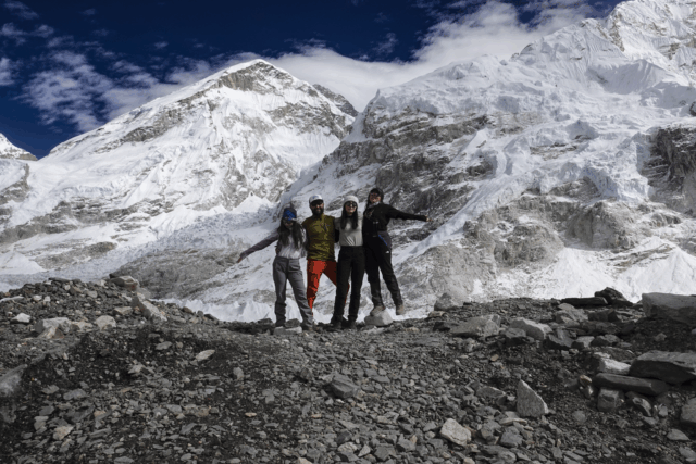 Life Happens Outdoors community members and team leaders posing together at Everest Base Camp on the Nepal trek.