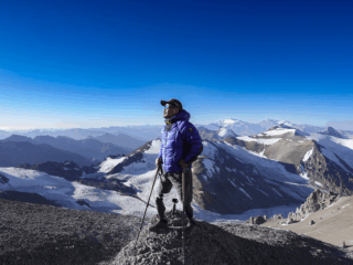 Hari Budha Magar at Camp 2 on Aconcagua, enjoying a clear blue sky after ascending from Camp 1, supported by Life Happens Outdoors.