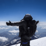 Life Happens Outdoors climber standing on the summit of Mont Blanc at 4,810 m, celebrating a successful ascent.