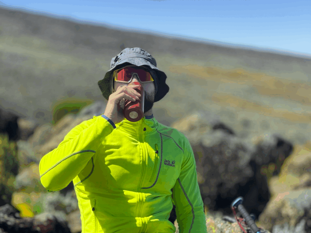 Life Happens Outdoors community member pauses to rehydrate on the way to Lava Tower on the Machame Route while climbing Kilimanjaro