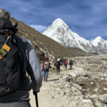 Life Happens Outdoors community members trekking toward Everest Base Camp with Pumori mountain in the distance on the EBC trail