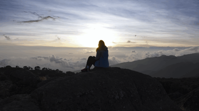 Life Happens Outdoors community member watching the sunset from Shira Camp on Mount Kilimanjaro