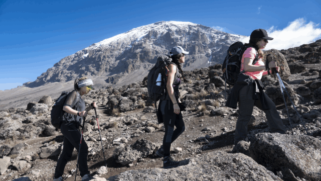 Life Happens Outdoors community members trekking from Karanga Camp to Barafu Camp on the Machame Route with Mount Kilimanjaro in the background.