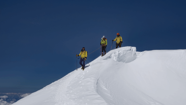 Life Happens Outdoors climbers crest the first mogul on the Mont Blanc summit push in clear weather
