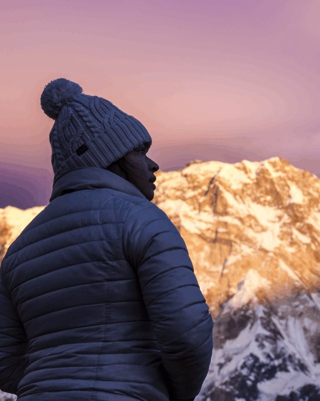Life Happens Outdoors community member enjoying a quiet solo moment at Annapurna Base Camp with the south face of Annapurna in the background.