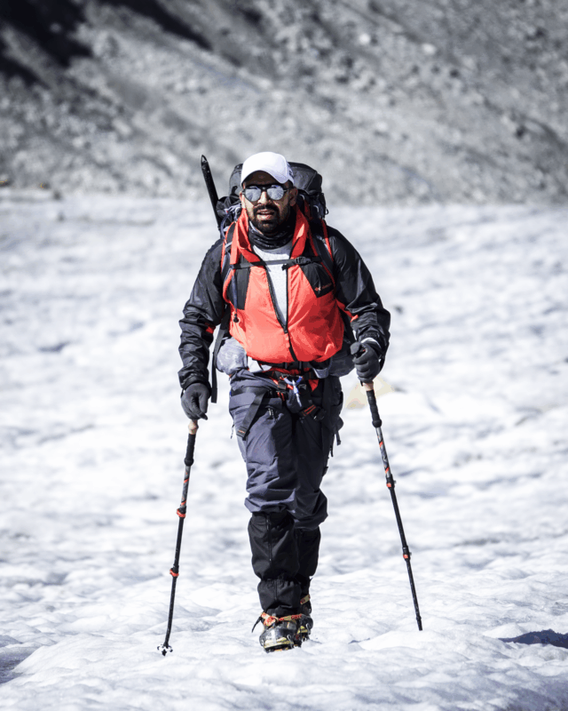 Life Happens Outdoors team member on his first day glacier hiking, stepping onto a glacier in the Alps.