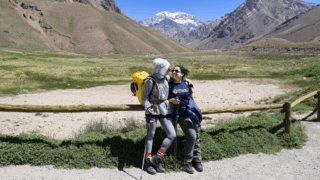 Life Happens Outdoors Team Leader walking with and encouraging a Life Happens Outdoors community member moments before the summit of Kilimanjaro.