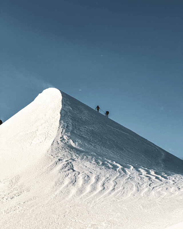 Life Happens Outdoors team roped together climbing Mont Blanc on summit day in the Alps.